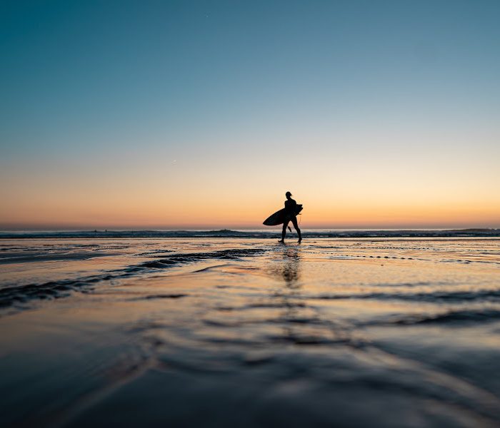 Surfer coming back from the ocean